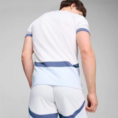 a man in white and blue shorts with his back to the camera