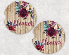 two wooden coasters with flowers and the word elanor on them, sitting next to each other