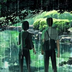 two people standing in the rain looking at water