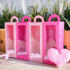 three pink bags with hearts in them sitting on a table