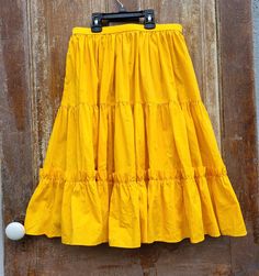 Vintage Rockabilly Square Dance Ranch Wear  Yellow Circle Skirt - excellent Full circle skirt that hits around knee length.  Happy mustard yellow. Waist measures 28".  Overall Length 25 3/4".  Zipper on back. Please view all pictures closely for additional description. Be sure to ask any questions that you may have. We strive to earn your trust and satisfaction. Your item will be packaged with great care and professionally shipped within two business days of payment received. SHIPPING IS FREE! Yellow Gathered Tiered Skirt, Retro Yellow Flared Skirt, Yellow Tiered Gathered Skirt, Vintage Yellow Cotton Skirt, Ranch Wear, Square Dancing, Marine Uniform, Full Circle Skirts, Circle Skirt