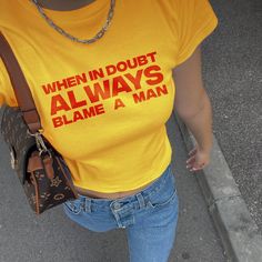 When In Doubt Always Blame A Man Baby Tee 💖 ✨ Make a bold statement with our "When In Doubt Always Blame A Man" Baby Tee! This Y2K-inspired crop top is perfect for those who love 90s and 2000s fashion. With a sassy slogan and classic fit, it's a must-have for your wardrobe. Pair it with your favorite low waist jeans or skirt for a nostalgic yet trendy look. Whether you're going out with friends or looking for the perfect y2k inspired outfit, this graphic tee is sure to turn heads and spark conv 90s Inspired Letter Print T-shirt For Streetwear, Y2k Letter Print Tops For Streetwear, Y2k Style Letter Print Tops For Streetwear, Y2k Streetwear Top With Letter Print, Y2k Streetwear Tops With Letter Print, Y2k Letter Print Streetwear Top, Y2k Style Text Print T-shirt For Streetwear, Funny Text Print Streetwear Top, Trendy Yellow Tops With Logo Print