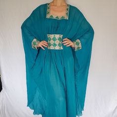 This Custom Oriental Arab Styled Evening Dress Was Bought In Dubai. Hand Made With Swarovski Crystals. This Dress Was Never Worn Besides In The Photos Above. Comes With A Under Dress. It Will Perfectly Fit A Size From Xs-L My Wife Is 5,10” (She Is On The Pics) For Reference If You Have Any Questions Please Let Me Know! Festive Turquoise Long Sleeve Dress, Turquoise Long Sleeve Festive Dress, Blue Bollywood Style Long Sleeve Kaftan, Blue V-neck Kaftan For Party, Fitted Silk Blue Kaftan, Fitted Blue Silk Kaftan, Blue Fitted Long Sleeve Kaftan, Blue V-neck Kaftan For Evening, Blue Silk V-neck Kaftan