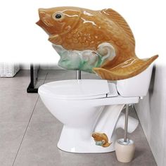 there is a toilet with a fish decoration on it