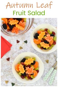 two white bowls filled with fruit salad on top of a table next to an orange and green napkin