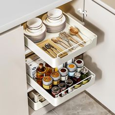 an open drawer in a kitchen filled with dishes and utensils