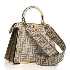 This is an authentic FENDI Chenille Suede Metal FF Small Peekaboo I SEE U Satchel in Tortora and Nuvola. This chic bag is crafted of Fendi embossed canvas in beige. It features silver and gold hardware top handles, gold trim, and polished gold hardware links. The top opens to a matching canvas interior with a hanging snap pocket. Chic Bags, Silver And Gold, Gold Trim, Gold Hardware, Satchel, Fendi, Handles, The Top, Trim