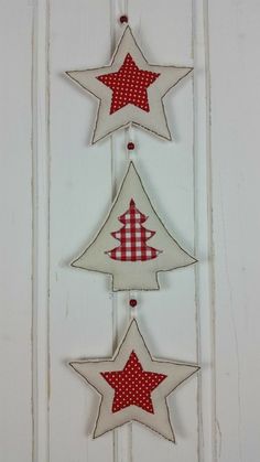 three red and white stars hanging from the side of a door