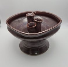 two brown vases sitting next to each other on a table