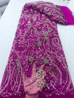 This high quality Fabric is measured in 5 Yards With Embroidered Beading and Sequin. It is soft, very delicate and beautiful. This high Quality Fabric is made with Fashion embroidered rhinestones can be used in making party wedding dresses, skirts, shawls, scarves and other other fashion apparels as you would like. Size : Length : 5 yards (180 inch). Width: 50 inch (Please allow slight deviation for the measurement data ,±1 inch) Material: 100% Polyester, Tulle Lace Fabric, Eco-Friendly embroide Elegant Purple Embroidered Fabric With Sequins, Elegant Embroidered Fabric With Rhinestones For Festive Season, Elegant Embroidered Fabric With Rhinestones For Festive Occasions, Elegant Embellished Purple Sequin Fabric, Purple Party Embroidered Fabric With Intricate Embroidery, Pink Beaded Lace Fabric, Pink Beaded Embroidered Fabric For Party, Pink Beaded Lace Embroidered Fabric, Pink Embroidered Fabric With Rhinestones For Wedding