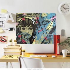 a computer desk topped with a desktop computer next to a wall mounted clock and painting