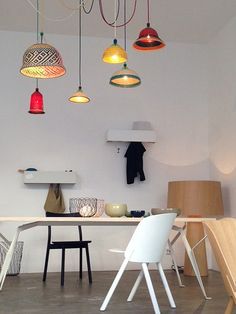 a room with several different colored lights hanging from the ceiling and various chairs on the floor