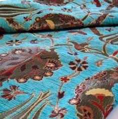 two blue and brown rugs sitting next to each other on top of a white table