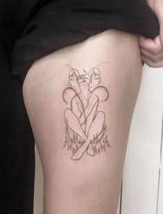 a person with a tattoo on their thigh