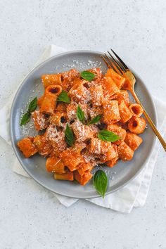 a plate of pasta with sauce and parmesan cheese