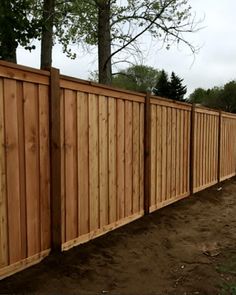 a wooden fence in the middle of a yard