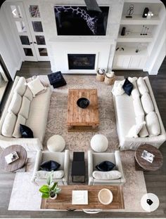 an aerial view of a living room with couches, tables, and fireplaces