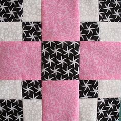 a pink and black quilt with white stars on it