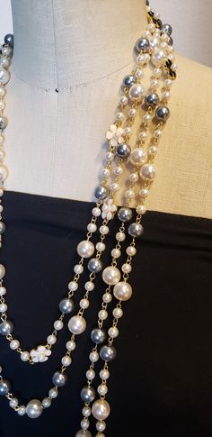 Description: Inspired to accessorize that black dress worn by Audrey Hepburn in Breakfast at Tiffany's, this beautiful extra long Vintage style Multi strand faux pearl necklace is sure to garner attention and turn heads! Really adds flare to that 'little Black Dress" This is a Chandra's Treasures original piece. I use beautiful lustrous imitation pearls for this piece with double sided black and white floral motifs containing a small faux pearl centerpiece. There are many ways to wear this neckl Layer Pearl Necklace, Statement Pearl Necklace, Pearl Necklace Long, Pearl Centerpiece, Multi Strand Pearl Necklace, Layered Pearl Necklace, Pearl Statement Necklace, Long Pearl Necklaces, Breakfast At Tiffany's