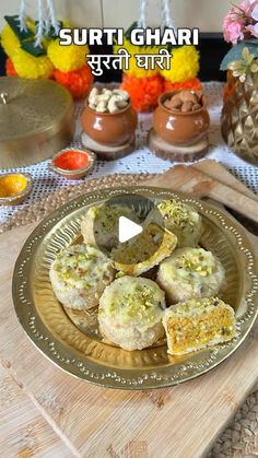 some food is on a gold plate with flowers in the background and an advertisement for sufti ghar