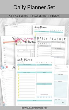 the printable daily planner set is shown on top of a marble surface with flowers