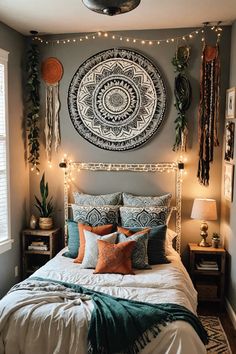 a bed with pillows, blankets and lights on the headboard is decorated in an ethnic style