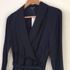 Brooks Brothers Faux Wrap Navy Silk/Wool Dress Size 4 New With Tags - Excellent Condition. V-Neck With Beautiful Collar; Faux Wrap Elastic Waist With Sash; Side Zipper; Long Sleeve With Buttons; And Navy Blue Color Dress. Spring V-neck Dress For Office, Blue Fall Dress For Work, Fall Office Wear V-neck Dress, Fall Viscose Midi Dress With Tie Waist, Fall Midi Dress With Tie Waist In Viscose, Fall Office Dress With Surplice Neckline, Blue Fall Dress For Workwear, Office Dress With Surplice Neckline For Fall, Chic V-neck Midi Dress For Business