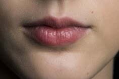 a woman's lips and nose are shown in close up