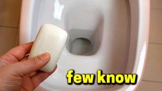 a person is holding an item in front of a urinal with the words few know on it