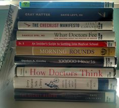 a stack of books sitting on top of a desk