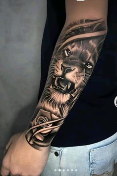 a man's arm with a lion tattoo on it and roses in the background