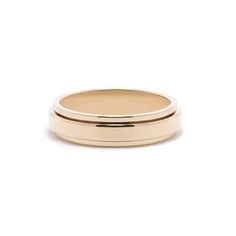 a gold wedding ring on a white background