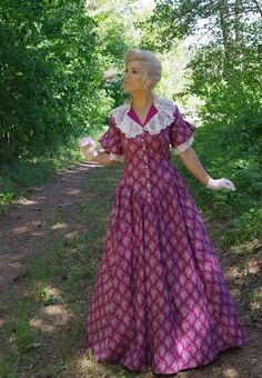 This charming cotton print prairie dress has flattering V-shape waist and neckline. The dress has contrasting solid cotton lace trimmed collar and lace flounced short sleeves. The three-paneled skirt has pockets. Hand wash or machine wash gently. The model is wearing a crinoline and gloves which are priced separately. Designed and made proudly by Recollections in America! Hand or machine wash cold gently; tumble dry low or hang to dry. Proudly made in the USA by the Recollections team. Crinoline Pastoral Cotton Dresses With Lace Trim, Cotton Prairie Dress For Daywear, Prairie Style Ruffled Dresses For Daywear, Prairie Style Ruffle Dresses For Daywear, Short Sleeve Prairie Dress With Ruffles For Garden Party, Prairie Daywear Dresses With Ruffles, Prairie Ruffle Dress For Daywear, Short Sleeve Dress With Lace Collar For Daywear, Fitted Short Sleeve Prairie Dress For Daywear