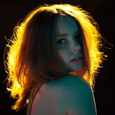 a woman with long hair and glowing light