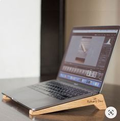 an open laptop computer sitting on top of a wooden desk