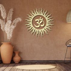 there is a wall decoration with the sun in the middle and an om symbol on it