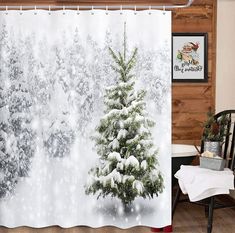 a shower curtain with a snowy christmas tree on it in front of a wood paneled wall