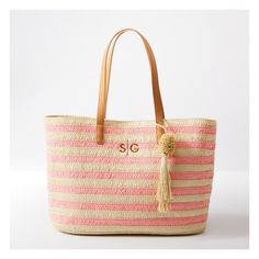 Take summery nautical style wherever your roam with this roomy straw bag. Designed for all your essentials for sunbathing on the sand or lazing by the lake, this sophisticated tote is equally at home in town as an everyday carryall. Crocheted from alternating colors of paper straw for a striped design, with a pom pom tassel and vegan leather handles for comfortable toting. Add a custom monogram to make it your own.    21"w x 6"d x 13"h  Handle drop: 9.5"  100% paper; vegan leather (polyurethane) Beachy Sand-colored Straw Bag, Pink Shoulder Bag With Leather Handles For Vacation, Large Capacity Weekender Bag For Summer Shopping, Pink Woven Beach Bag For Summer, Summer Beach Weekender Bag In Rectangular Shape, Pink Chic Beach Bag For Vacation, Rectangular Summer Weekender Bag For Beach, Summer Rectangular Weekender Bag For Beach, Summer Travel Weekender Bag In Beige