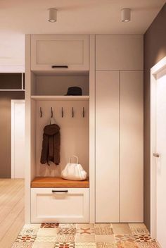 a white coat rack sitting inside of a closet