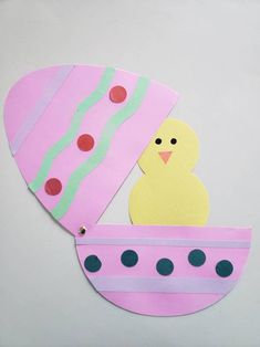 a paper cut out of a pink boat with a chick in it's center