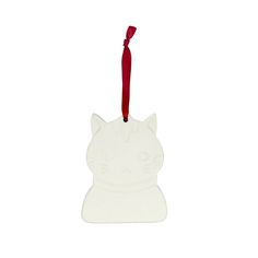 a white cat ornament hanging from a red ribbon on a white background,