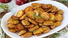 a white plate topped with fried potatoes on top of a table