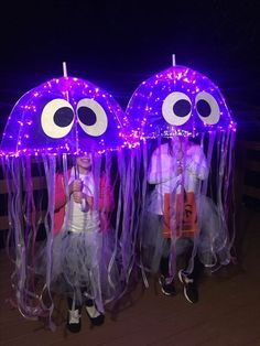 two children dressed up as jellyfishs with purple lights