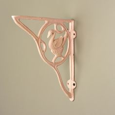 a decorative wall bracket with a bird on it