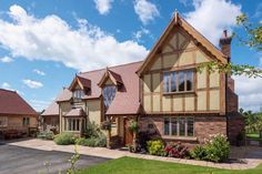 a large house sitting on top of a lush green field