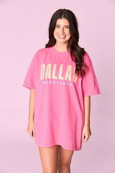 Make a statement with this Dallas Tee! Crafted from Comfort Colors, this tee is perfect for lounging or rocking oversized. Get your true size for a classic fit or size up for a more laid-back vibe. What better way to show off your Dallas and BuddyLove pride? Oversized Text Print T-shirt For Spring, Relaxed Graphic Print T-shirt For Loungewear, Pink Slogan T-shirt For Loungewear, Oversized Pink Slogan Top, Urban Pink Tops For Spring, Urban Style Pink Tops For Spring, Oversized Pink Top With Text Print, Trendy Relaxed Fit T-shirt For Loungewear, Oversized Screen Print T-shirt For Spring