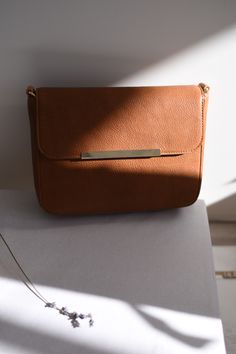 This minimalist but spacious crossbody bag made of full grain leather will add a touch of sophistication to your every day wardrobe. Elegant Phone Bag With Adjustable Strap As Gift, Chic Phone Bag With Detachable Strap As Gift, Modern Phone Bag As Gift, Chic Crossbody Phone Bag As Gift, Chic Crossbody Phone Bag For Gifts, Chic Shoulder Bag With Adjustable Strap As Gift, Satchel Phone Bag Gift, Chic Flap Bag With Cell Phone Pocket, Chic Phone Bag With Cell Phone Pocket As Gift