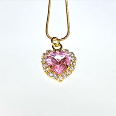 An elegant pink crystal heart on a delicate gold chain. Pink Gold Plated Necklace For Anniversary, Rose Gold Heart-shaped Chain Necklace, Gold Heart Beads Necklace For Party, Valentine's Day Gold Chain Heart Necklace, Valentine's Day Heart Necklaces With Gold Chain, Valentine's Day Heart Shaped Gold Chain Necklace, Valentine's Day Heart Necklace With Gold Chain, Pink Delicate Chain Wedding Jewelry, Pink Heart Beads Necklace For Anniversary