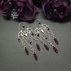 These Bat Chandelier Earrings have the perfect vampire vibes and showcase a victorian, gothic style. Enhance your nocturnal look and pair with our Chokers, Necklaces, Rings, and Bracelets. Details: Fashion Jewelry ~ Handmade Total Length: 92mm Width: 32mm Made with Red & Black Glass Crystal Beads Gothic Handmade Jewelry, Diy Goth Jewelry, Bat Chandelier, Vampire Accessories, Vampire Vibes, Gothic Jewelry Diy, Vampire Earrings, Vampire Jewelry, Vampire Fashion