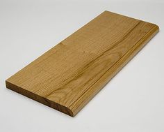 a piece of wood sitting on top of a white table